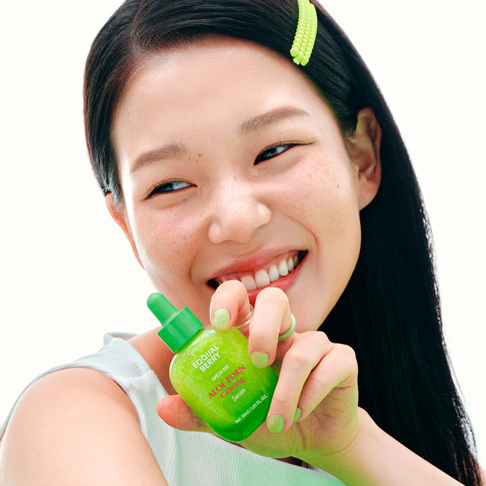Green aloe vera serum bottle with dropper on a white background